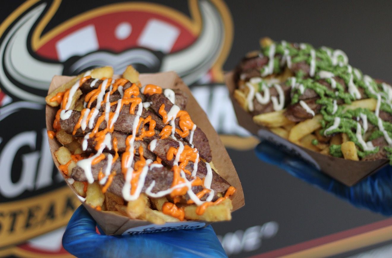 Steak over chips with house sauces